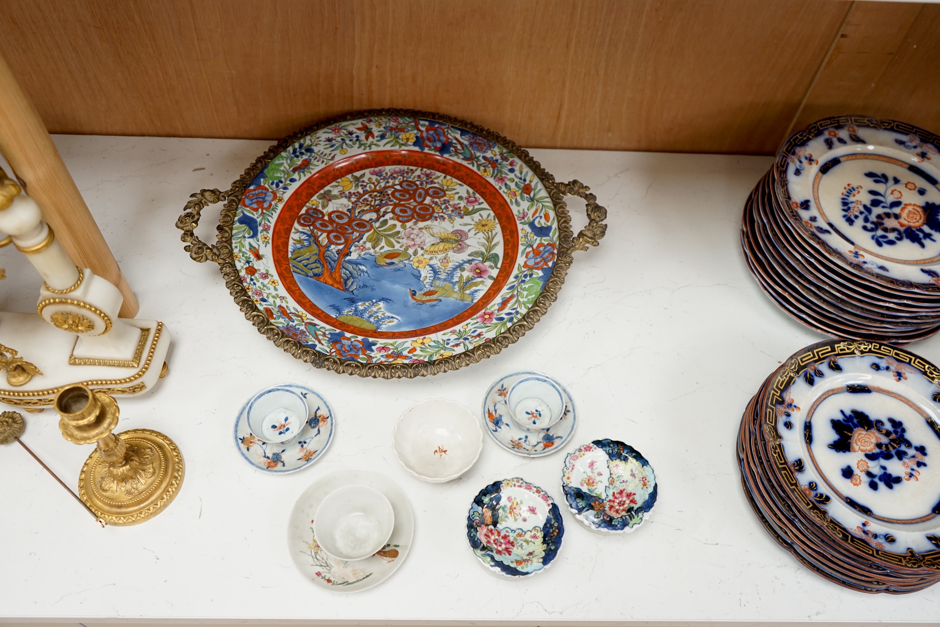 A pair of 18th century Chinese export tobacco leaf pattern pedestal salts, a clobbered Chinese dish (a.f.), now mounted with gilt metal rim, etc., 41cm diameter, together with four 18th century Chinese tea bowls, and thr